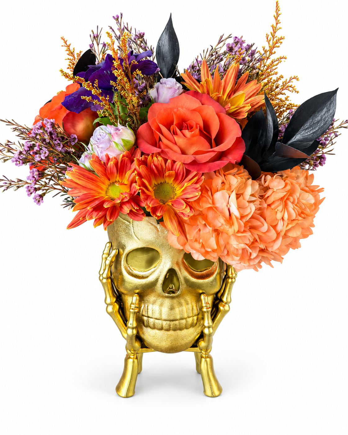 Orange and purple Halloween flowers in a gold skull vase